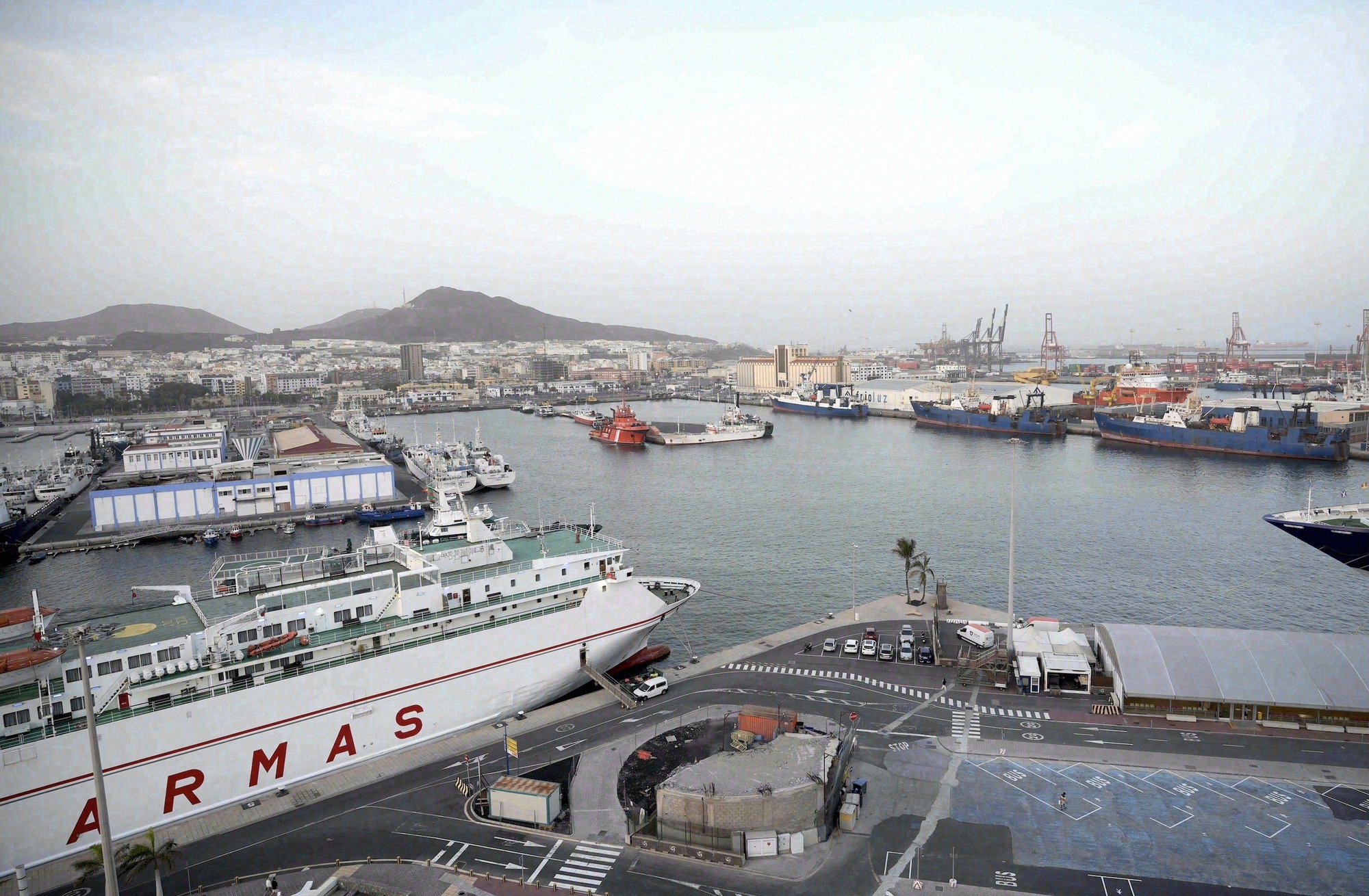 Suuri satamapanoraama Las Palmasista rahti- ja lauttalaivoineen (Naviera Armas) Puerto de La Luzissa. Satama ja kaupungin siluetti ylhäältä.